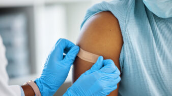 doctor applying a band aid to a patient's arm
