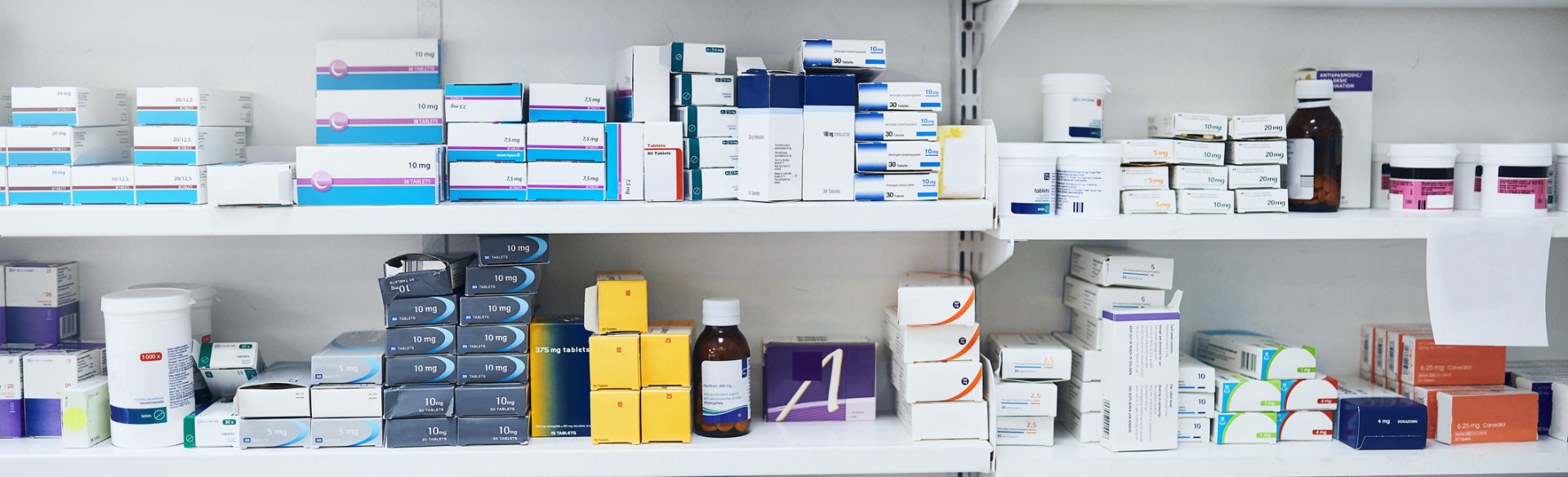 pharmacy shelf with various medications and prescriptions