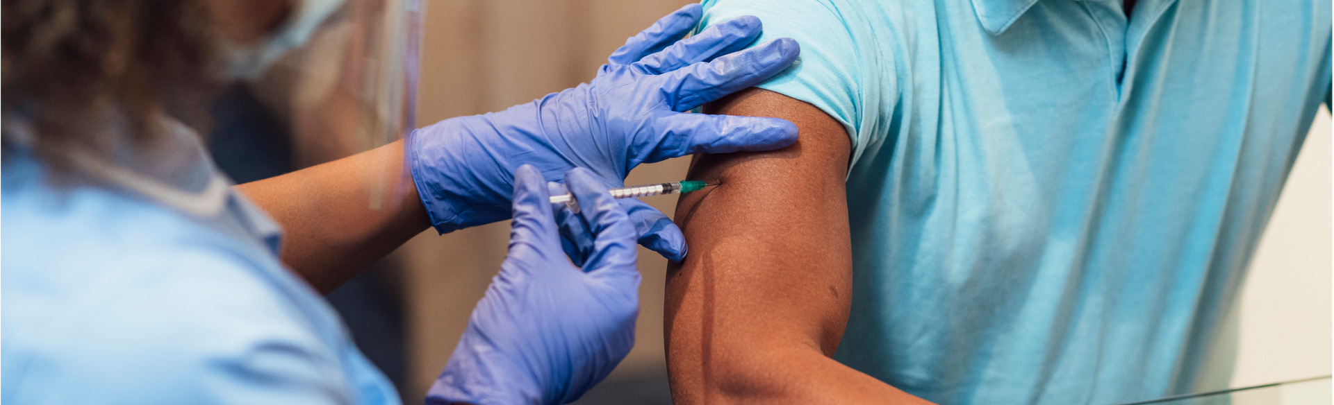 medical professional administering a vaccine