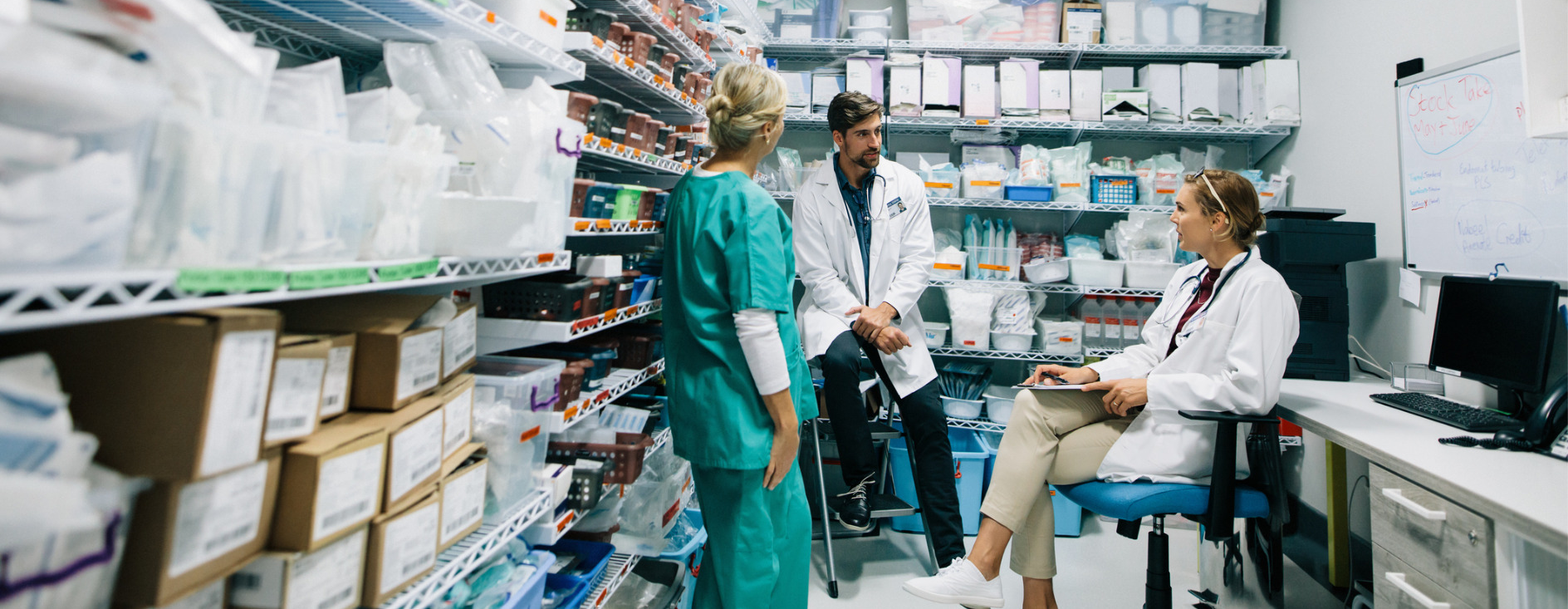 hospital Pharmacy with three staff members talking