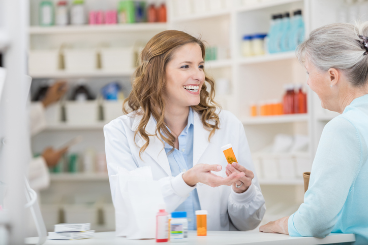 female pharmacist helping a senior patient