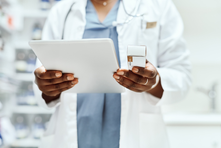 close up of a pharmacist looking at a tablet device