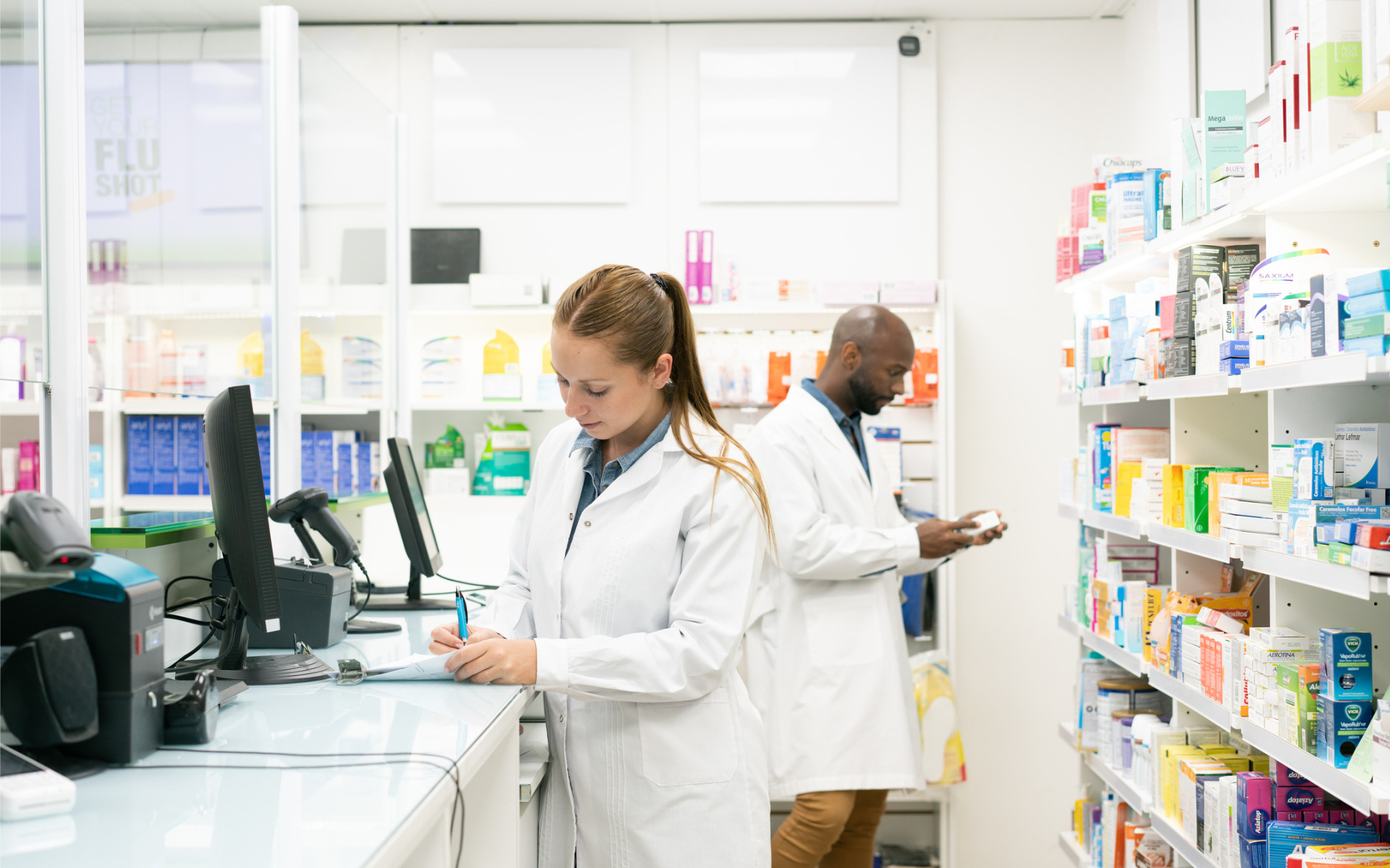 two pharmacists working in a community pharmacy
