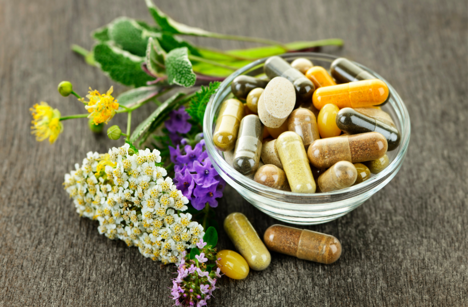 herbal medicines and supplements surrounding and in a glass bowl