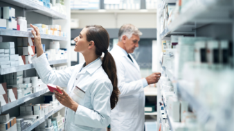 two pharmacists checking medication stock