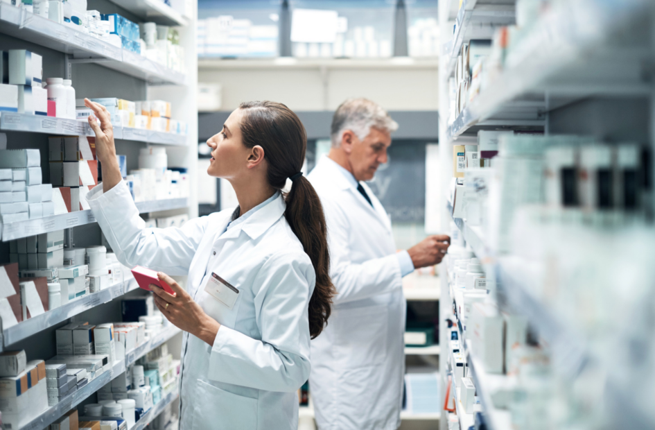 two pharmacists checking medication stock in the pharmacy stock room
