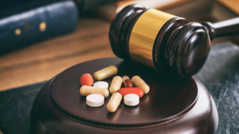 close up of a gavel and pills