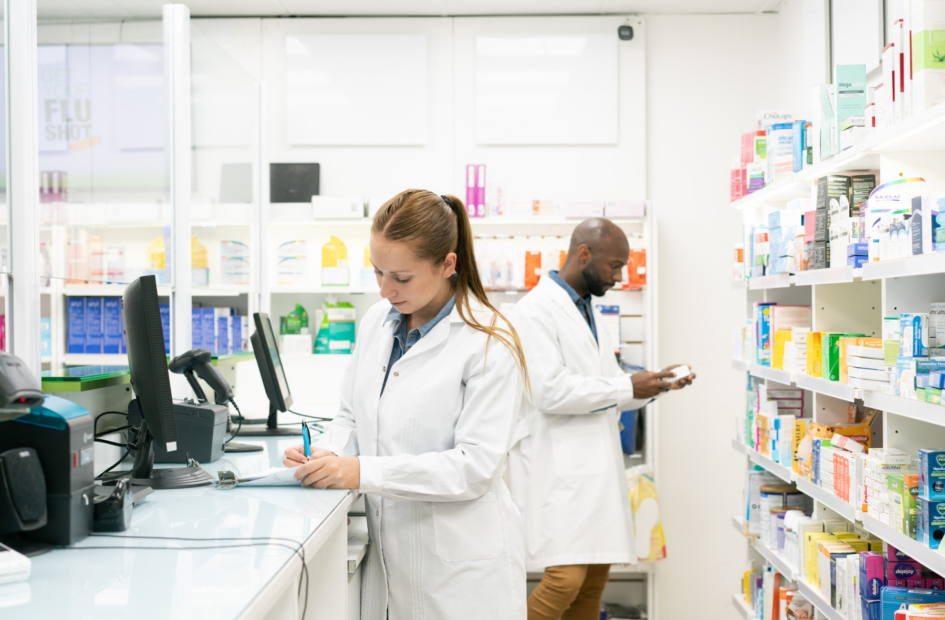 two retail pharamcists filling prescriptions