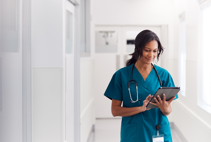 nurse looking at a tablet device in a hospital