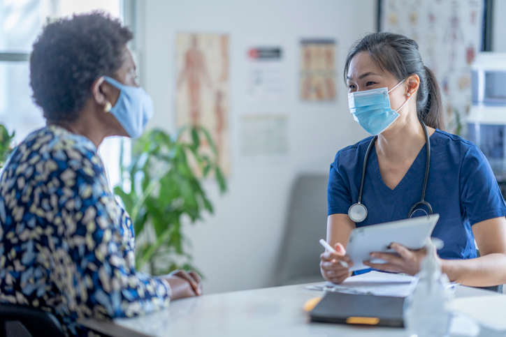nurse sitting and talking with a patient