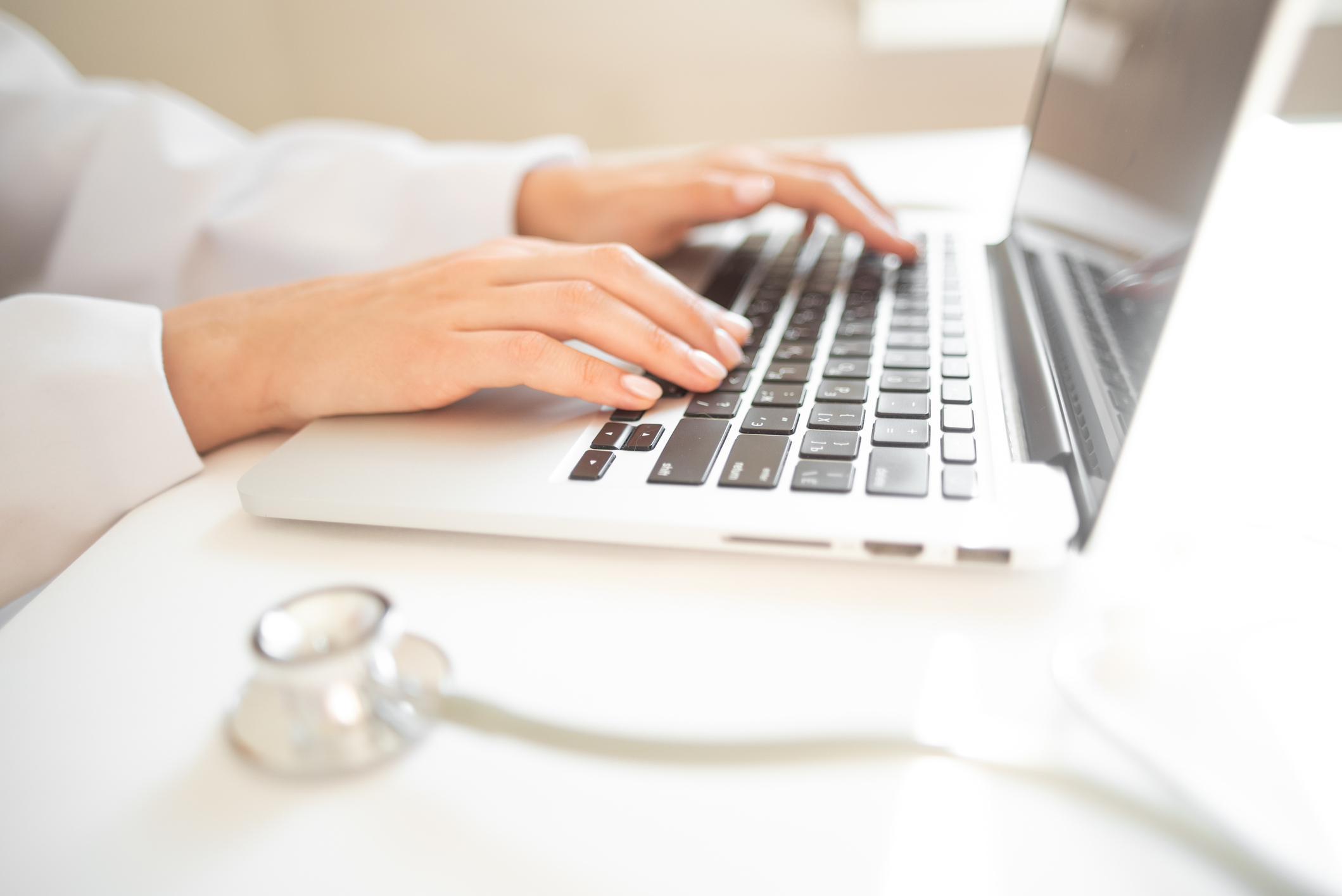 Pharmacist typing on laptop