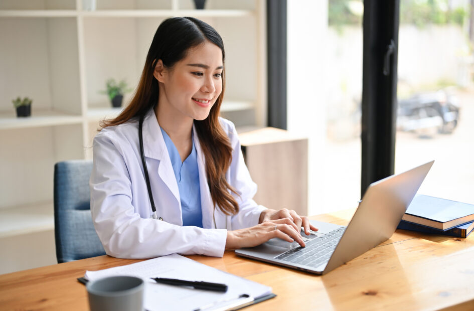 Pharmacist using laptop in workspace