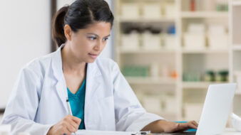 Pharmacist using computer to complete continuing education requirements