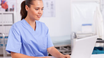 female technician on computer in pharmacy