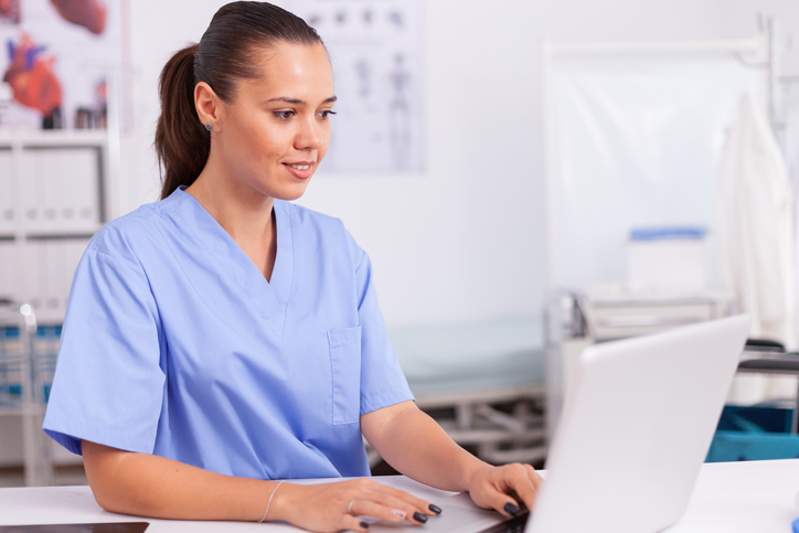 female technician on computer in pharmacy