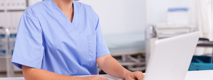 technician on computer in pharmacy