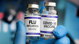 close up of flu and covid vaccines