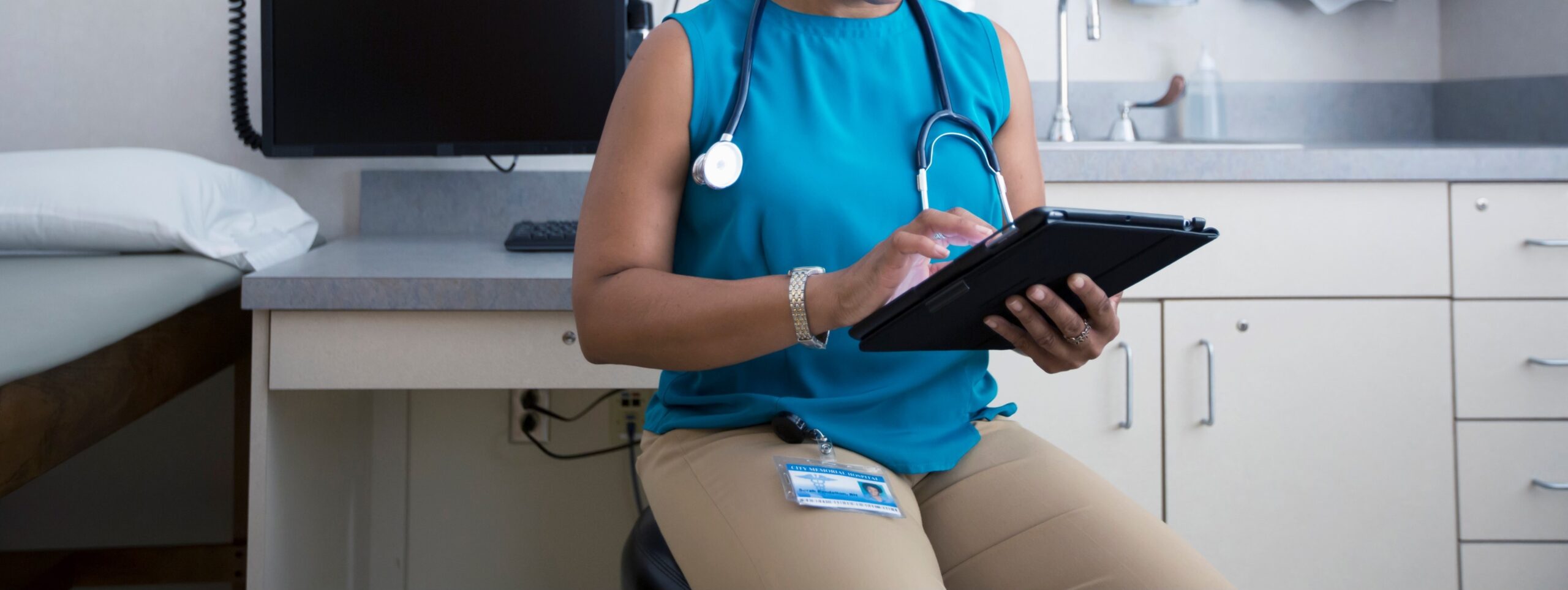 Healthcare professional in clinic using a tablet