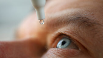 close up of man administering eye drops