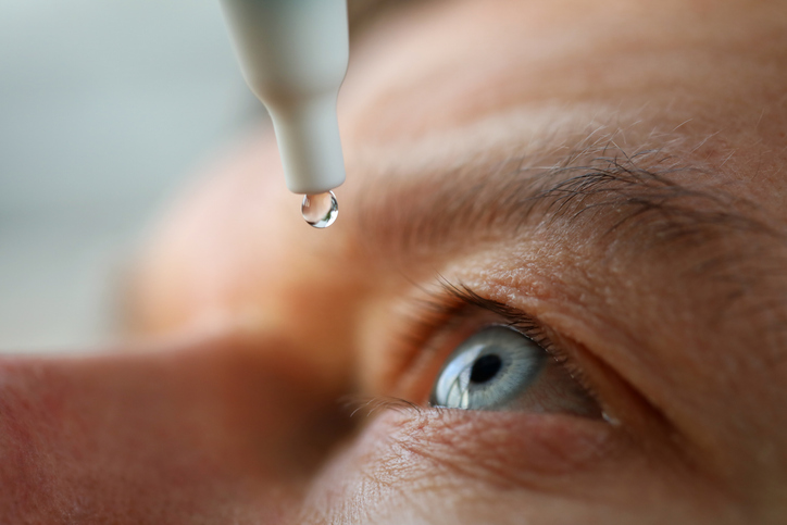 close up of man administering eye drops