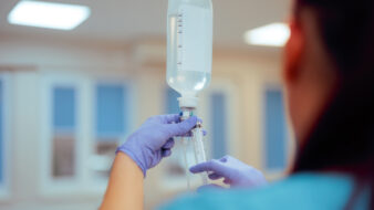 Nurse Preparing Iv Bag Injecting Medication in a Hospital