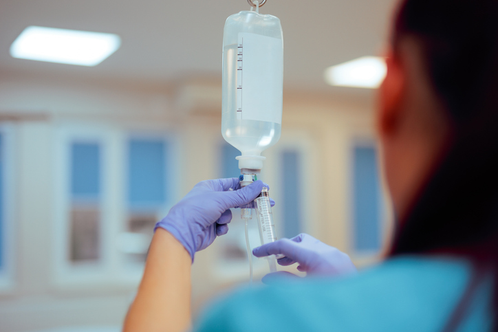 Nurse Preparing Iv Bag Injecting Medication in a Hospital