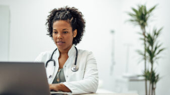 female doctor working on a laptop