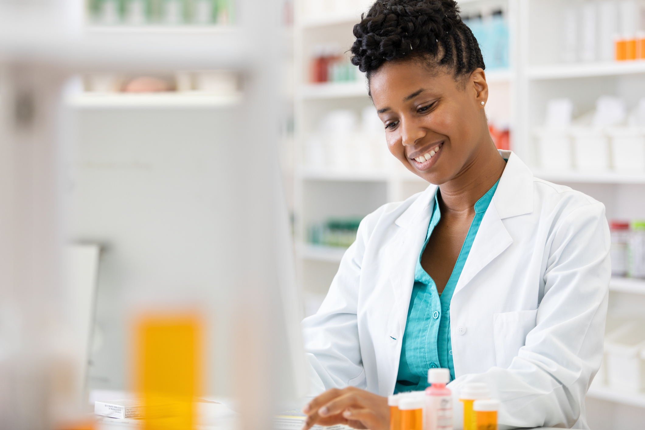 young woman on computer in pharmacy