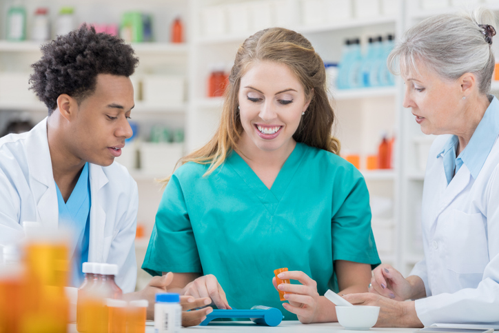 pharmacy staff working behind the counter